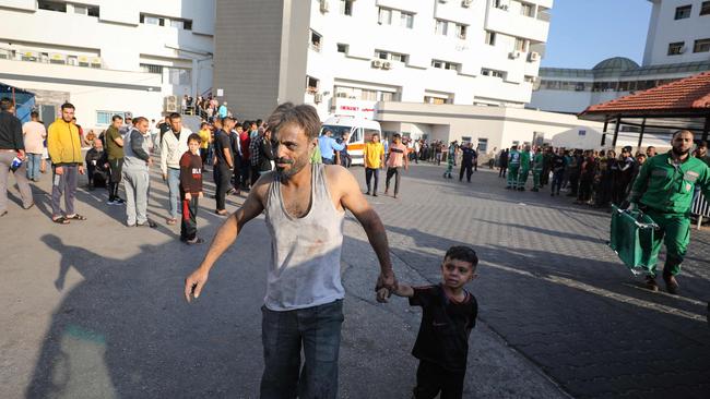 An injured Palestinian man and boy arrive to Al-Shifa hospital in Gaza City following Israeli bombardment. Picture: Dawood Nemer / AFP