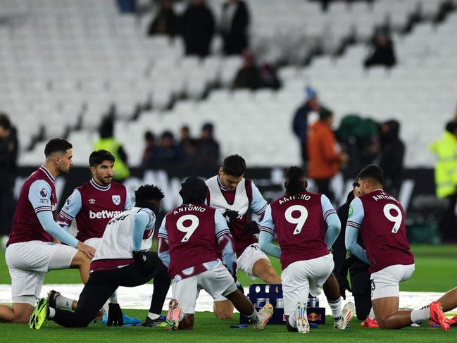 West Ham United's team-players wear the shirt of his teammate West Ham United's English forward #09 Michail Antonio as part of tribute following his car accident, during the warm-up prior to the English Premier League football match between West Ham United and Wolverhapton Wanderers at the London Stadium, in London on December 9, 2024. West Ham said forward Michail Antonio has undergone surgery on a lower limb fracture after a serious car accident on December 7, 2024. (Photo by Adrian Dennis / AFP) / RESTRICTED TO EDITORIAL USE. No use with unauthorized audio, video, data, fixture lists, club/league logos or 'live' services. Online in-match use limited to 120 images. An additional 40 images may be used in extra time. No video emulation. Social media in-match use limited to 120 images. An additional 40 images may be used in extra time. No use in betting publications, games or single club/league/player publications. /