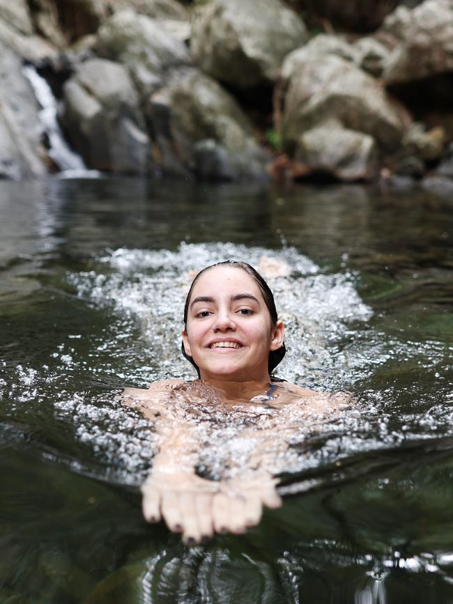 The weather in Far North Queensland is heating up, with the humidity increasing along with the temperatures. Charly Chautard, 19, of Edge Hill, cools off from the hot weather by taking a swim in Stoney Creek at Kamerunga. Picture: Brendan Radke