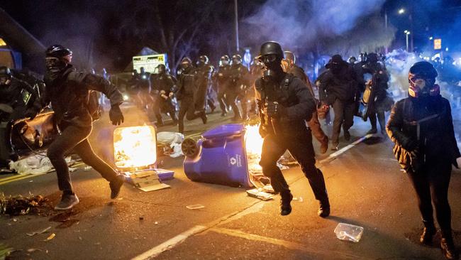 Portland police officers chase demonstrators when a riot was declared during a protest in the Oregon city last April after a black man was killed by police in Minnesota. Picture: Getty Images/AFP