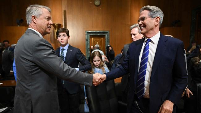 Republican Senator Roger Marshall congratulates Scott Bessent after his Senate Finance Committee hearing on his nomination to be Secretary of the Treasury. Picture: AFP