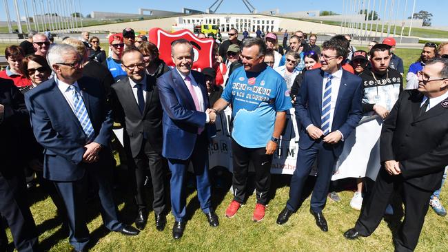 Salvation Army leader Brendan Nottle shakes hands with Bill Shorten after finishing his walk from Melbourne to Canberra at Parliament House.