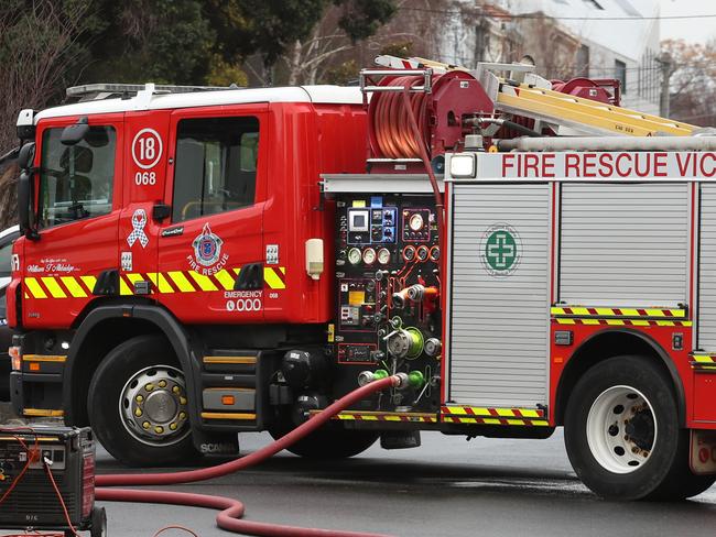 MELBOURNE, AUSTRALIA - NewsWire Photos, AUGUST 17, 2021. Police and fire fighters at the scene where following the arrest of a man following a fire at a service station in Fitzroy overnight: NCA NewsWire / David Crosling