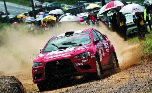 Rally driver Katsu Taguchi says he’s “a little worried” ahead of this weekend’s rally in the forests around Imbil. He is pictured in action in his Mitsubishi Lancer. Picture: Contributed