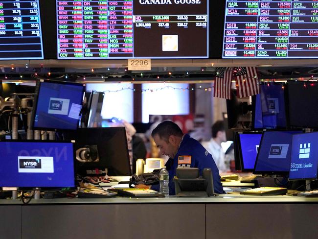 A trader reacts on the floor of the New York Stock Exchange at the closing bell on December 30, 2022 in New York. - Wall Street stocks marked a gloomy end to 2022, slumping to close lower in their worst annual showing in years. Surging inflation and steep interest rate hikes to cool demand have battered markets and investor sentiment this year, on top of global shocks like Russia's invasion of Ukraine. (Photo by TIMOTHY A. CLARY / AFP)