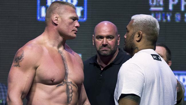 Brock Lesnar, left, looks at Mark Hunt during the UFC 200 weigh-ins.