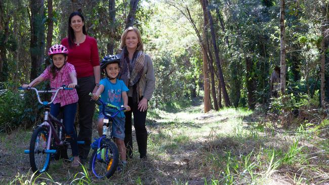 Christie Smith with Jasmine and Tyler McDonald and Cr Laurie Koranski on the disused track, which could be a cycling path.