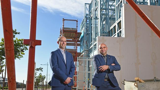 Stuart Zyhajlo, sales and marketing manager for SA builder the Hot Property Group with director and CEO Valentino Fuda in front of their Blakeview townhouses under construction. Picture: Tom Huntley