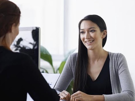 Shot of two young professionals having a discussion at a desk, Job interview, career, meeting, istock image.