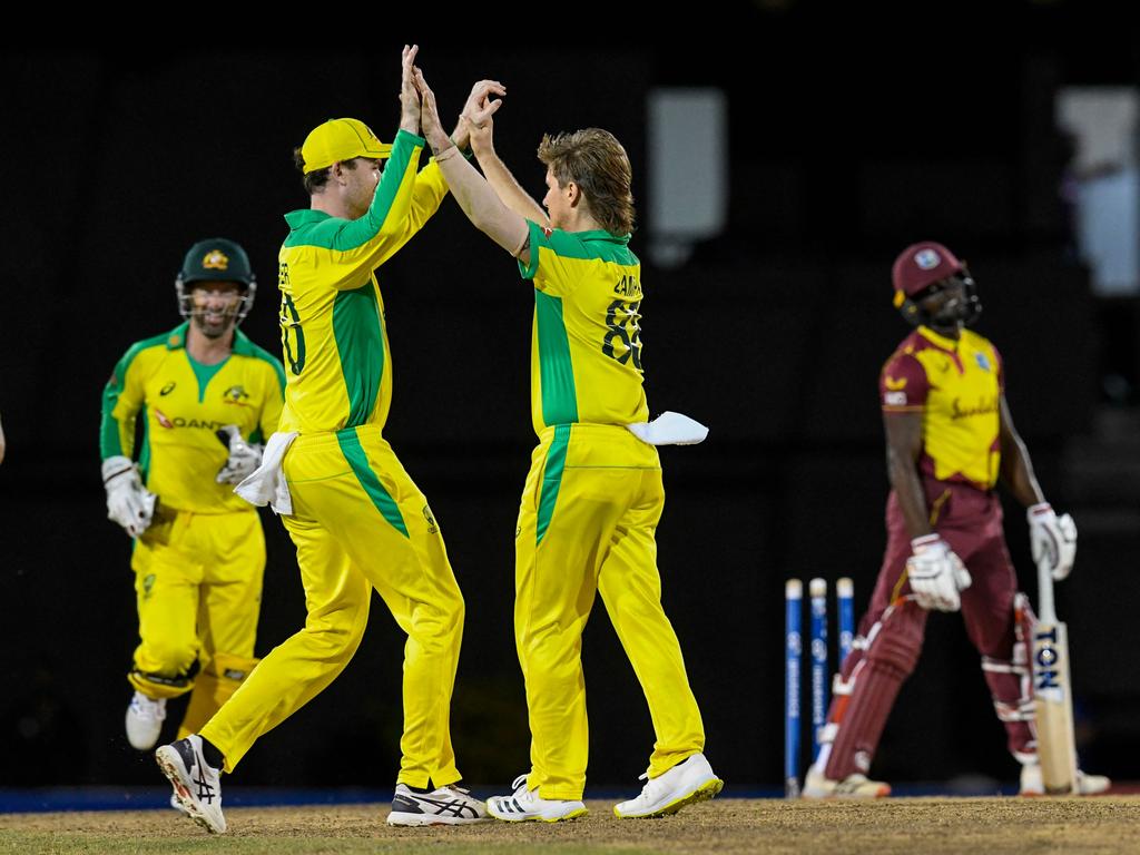 Adam Zampa (centre) celebrates with Ashton Turner after the dismissal of Andre Fletcher. Picture: Randy Brooks / AFP