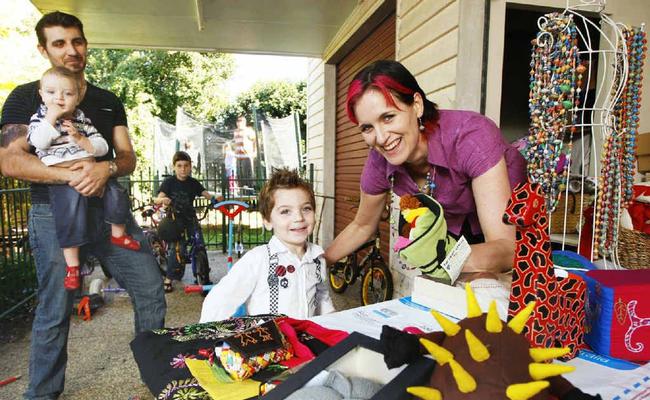 Mother-of-six Bec Draper shows off her fair trade handicrafts to Ezra (front), 3, and husband Brendan with Isaac, 1, and Noah, 9. Mrs Draper has been nominated for The AusMumpreneur Awards. Picture: David Nielsen