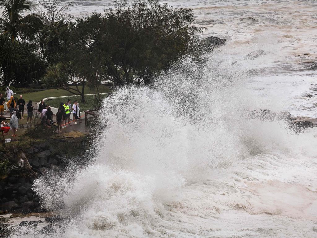 People watch record-breaking waves as the outer fringes of the Gold Coast. Picture: AFP