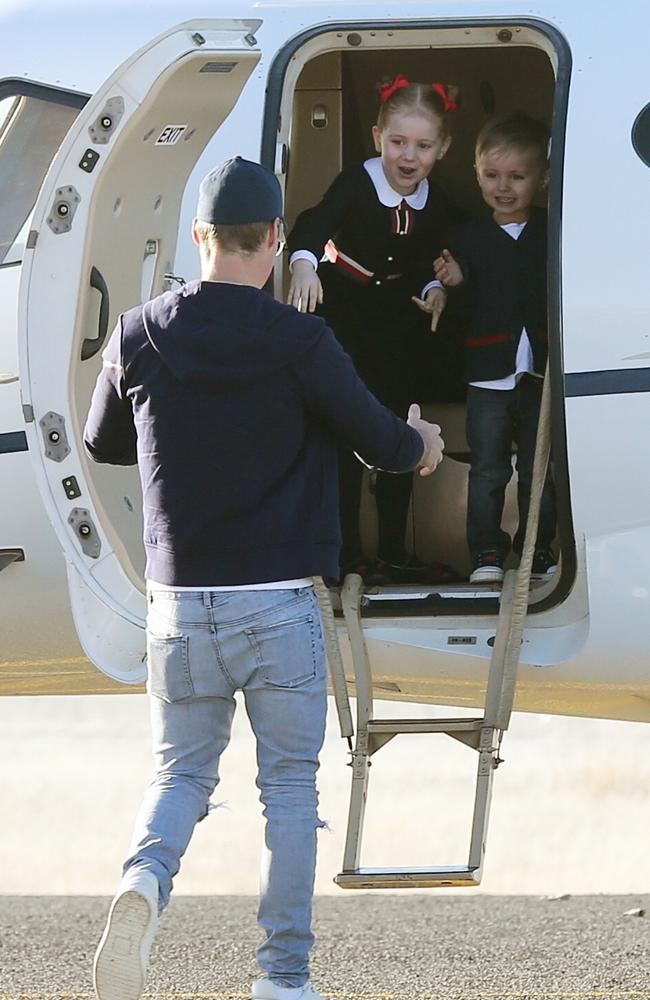 Oliver Curtis’ children welcome their father into the private jet that flew them to Sydney. Wife Roxy was also waiting inside. Picture: Stephen Cooper