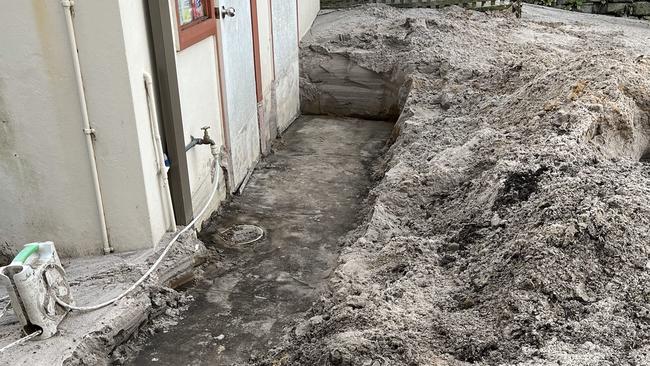 Overflow from the golf course sends mud and sand into the path of homes.