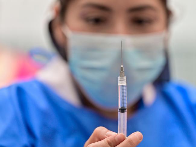 A health worker prepares a dose of the Pfizer-BioNTech vaccine.