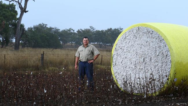 NSW cotton farmer Geoff Barwick with a cotton bale after harvesting on his property Yarrabah. Picture: Britta Campion / The Australian