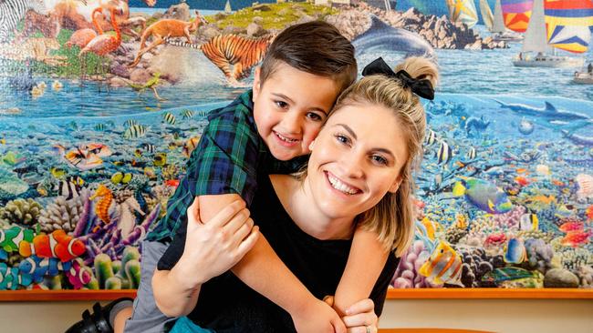 Tegan Anae with her son Sio, 5, at the Glenleighden School in Fig Tree Pocket. Picture: AAP/Richard Walker