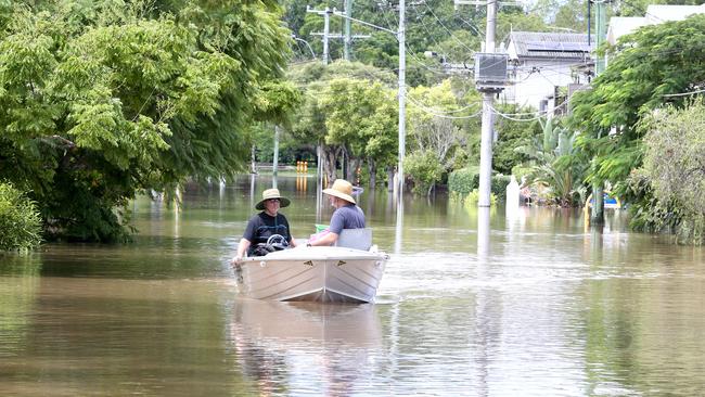 Ian Leabeater with Nick Pirie gather items from a flooded home at Graceville. Picture: Steve Pohlner