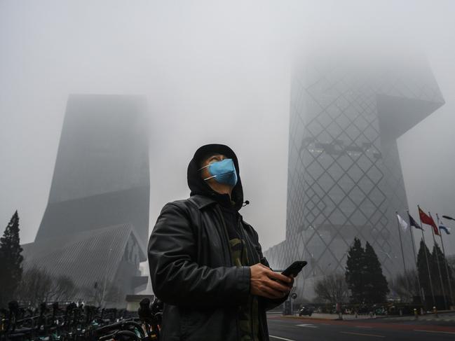 A Chinese man wears a protective mask as smog covers central Beijing. Picture: Getty