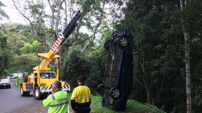 A crane was used to retrieve a car from down a 30-foot embankment off Tuntable Creek Road.. Picture: Marc Stapelberg