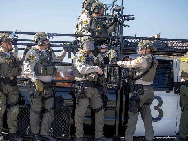 Law enforcement clash with demonstrators during a protest following federal immigration operations, in the Compton neighbourhood of Los Angeles, California. Picture: AFP