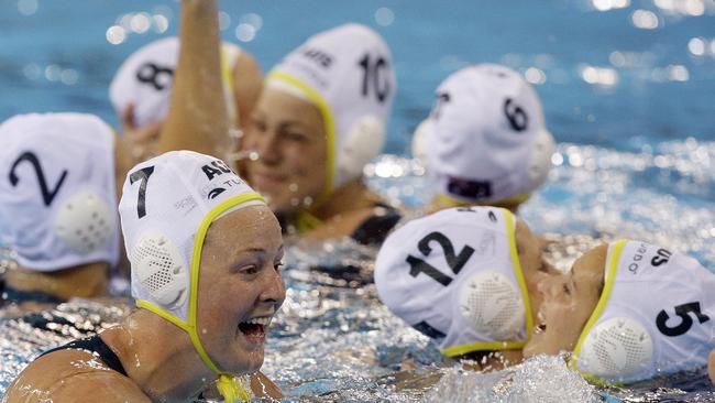 Australia players Taniele Gofers (7) and Suzie Fraser (5) celebrate with teammates after beating Hungary in the bronze medal women's water polo match at the Beijing Olympics. (AP Photo/Vincent Yu)