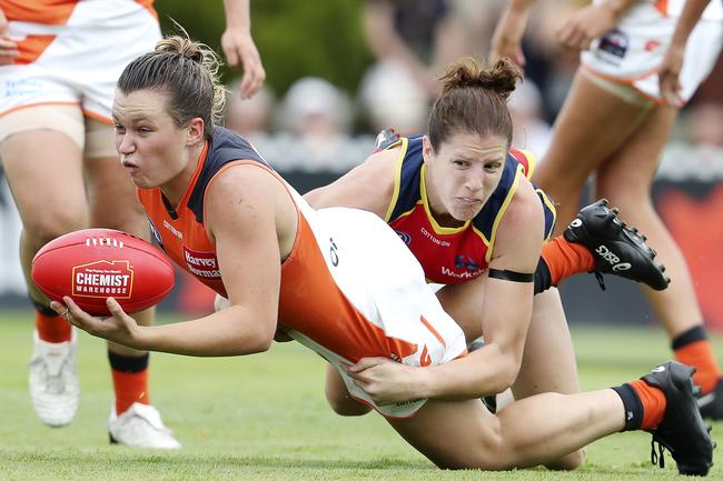 GWS Giants Alyce Parker gets her handpass out desipte the pressure from Crows Jessica Foley at Peter Motley Oval Picture Sarah Reed.