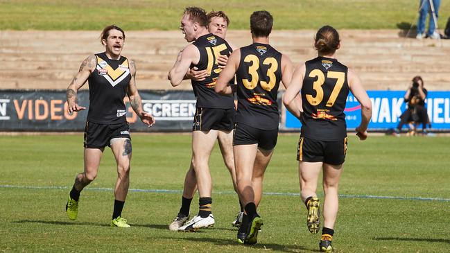 Brighton players celebrate a goal in last year’s division three grand final win against Golden Grove. Picture: AAP/MATT LOXTON)