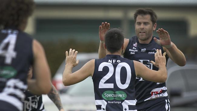 Noarlunga captain Tom Caudle celebrates a goal with teammate Reece Martell in the win against Flagstaff Hill. Picture: AAP Image/Dean Martin