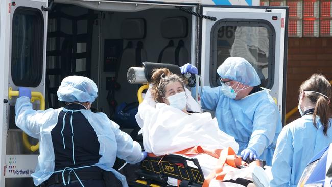 A woman arrives by ambulance to Wyckoff Hospital in the Bushwick section of Brooklyn, New York.