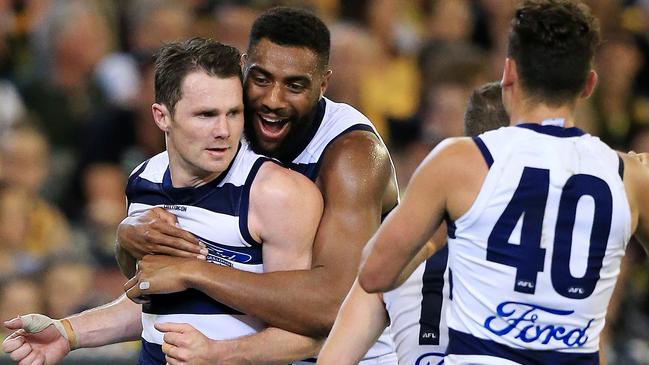 Patrick Dangerfield celebrates a goal with teammate Esava Ratugolea.