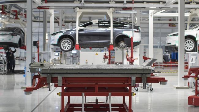 A battery pack stands on a trolley as Tesla Model X sports utility vehicles. Picture: Bloomberg