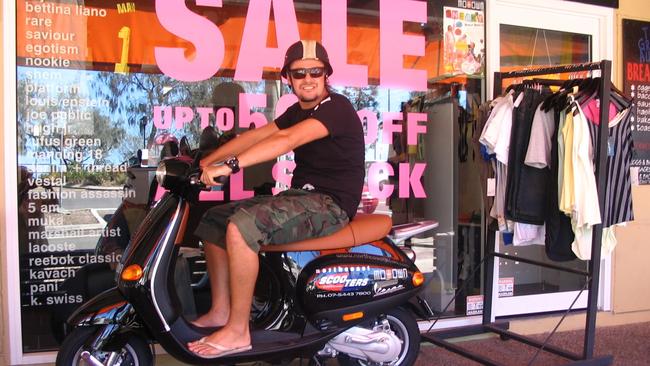 James Stewart on a moped he was gifted outside his streetwear store.