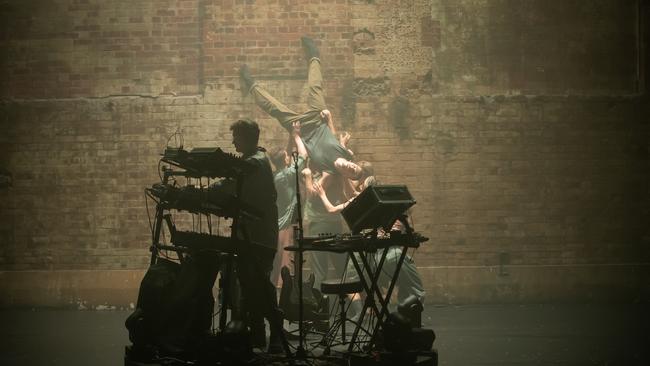 Danny Harley drives his console as the ADC dancers work the wall of the Powerhouse Theatre in Aftermath