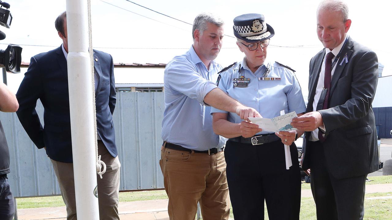 Qld Police Minister Mark Ryan, Qld Police Commissioner Katarina Carroll and QLD Police Union President Ian leavers, looking at the flowers and cards left at Chinchilla Police Station. Picture: Liam Kidston