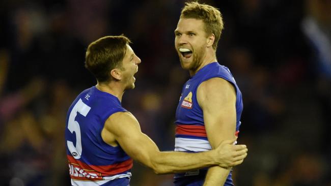 Jake Stringer of the Western Bulldogs is congratulated by Matthew Boyd of the Western Bulldogs as he leaps after he kicks a goal in the fourth quarter during the round 7 AFL match between the Western Bulldogs and the Adelaide Crows at Etihad Stadium in Melbourne, Saturday, May 7, 2016. (AAP Image/Tracey Nearmy) NO ARCHIVING, EDITORIAL USE ONLY