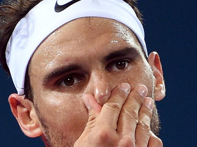 Rafael Nadal of Spain gestures during a point against Milos Raonic of Canada in their men's singles quarter-final match at the Brisbane International tennis tournament in Brisbane on January 6, 2017. / AFP PHOTO / Saeed KHAN / IMAGE RESTRICTED TO EDITORIAL USE - STRICTLY NO COMMERCIAL USE