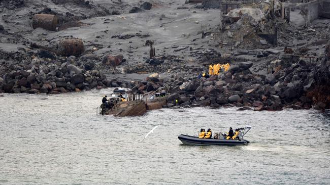 Soldiers taking part in a mission to retrieve some of the 22 bodies from White Island after the eruption. Picture: AFP.