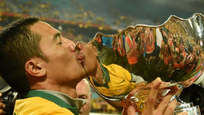Socceroos member Tim Cahill kisses the Asian Cup trophy. Picture: AAP