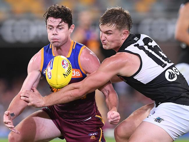 Lachie Neale of the Lions (left) competes with Ollie Wines of the Power during the Round 3 AFL match between the Brisbane Lions and Port Adelaide Power. Picture: AAP Image/Dave Hunt