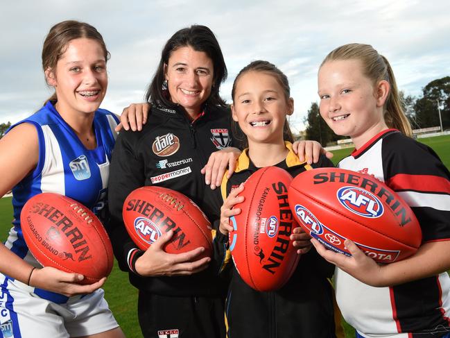 Saints assistant coach Peta Searle with junior footballers Emmy Frederico (L) Sophie Roynic and Mikayla Watson (R) at Trevor Barker oval, Sandringham Picture: Chris Eastman
