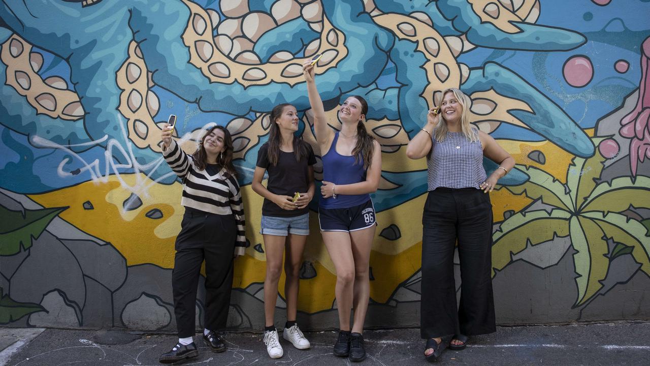 Gen Alpha teens Leonie Bailleul-Dumenil, 14, inside right, and Daisy Kluzek, 13, inside left, participated in the dumbphone experiment with Gen Z guinea pigs Ruby Stewart, 22, far right, and Talara McHugh, 22, far left. Picture: Brett Hartwig