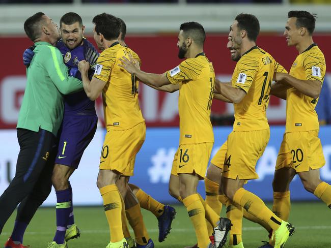 Australian players celebrate after scoring the winning penalty in a shootout at the end of the AFC Asian Cup round of 16 soccer match between Australia and Uzbekistan at the Khalifa bin Zayed Stadium in Al Ain, United Arab Emirates, Monday, Jan. 21, 2019. (AP Photo/Kamran Jebreili)