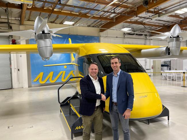 South East Queensland Council of Mayors chair Adrian Schrinner (left) with Wisk Aero chief executive Brian Yutko and one of the autonomous air taxis.