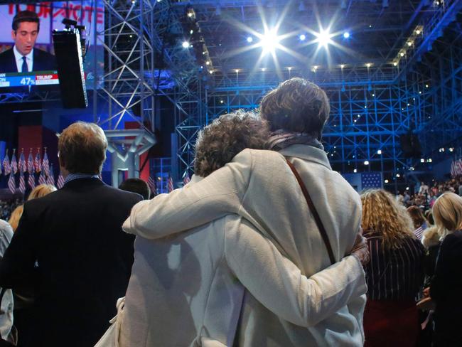 Supporters of Democratic presidential nominee Hillary Clinton react during election night at the Jacob K. Javits Convention Center in New York on November 8, 2016. / AFP PHOTO / Kena Betancur