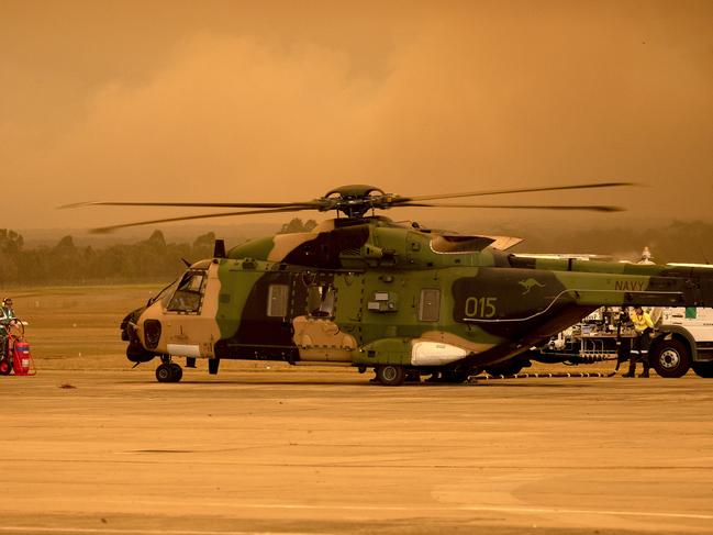 A MRH90 Taipan Military Support Helicopter on the 808 Squadron Flight line at HMAS Albatross, Nowra. *** Local Caption *** The Australian Defence Force is continuing to support Emergency Management Australia in firefighting efforts around the country.     Navy’s MRH-90 Taipan helicopters based at HMAS Albatross in Nowra have evacuated residents from Fishermans Paradise and North Sassafras on the South Coast NSW.     Day and night time aerial mapping of fires at Tianjara, Currowan and Forest continues.     ADF liaison officers are working side by side with emergency services personnel in the State Disaster Coordination Centre (SDCC) and within the New South Wales Rural Fire Service Headquarters.     Defence is also providing transport and other capabilities such as aviation ground support, logistics, engineering and accommodation to support the firefighting effort.