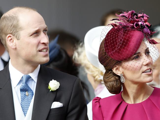 Prince William and Kate, Duchess of Cambridge, look up at the Royal Standard flying from the round tower following the wedding of Princess Eugenie. Picture: AP