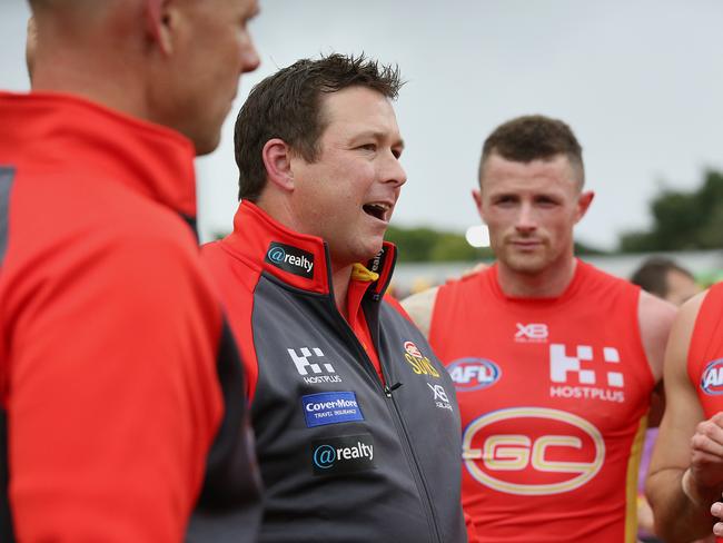 Suns coach Stuart Dew talks to his team during the round 16 AFL match between the Gold Coast Suns and the Richmond Tigers at Metricon Stadium on July 06, 2019 in Gold Coast, Australia. (Photo by Jono Searle/AFL Photos via Getty Images )