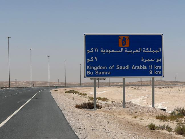 A picture shows a road sign near the Abu Samrah border crossing between Qatar and Saudi Arabia, on June 20, 2017. On June 5, Saudi Arabia and its allies cut all diplomatic ties with Qatar, pulling their ambassadors from the gas-rich emirate and giving its citizens a two-week deadline to leave their territory. The measures also included closing Qatar's only land border, banning its planes from using their airspace and barring Qatari nationals from transiting through their airports. / AFP PHOTO / STRINGER