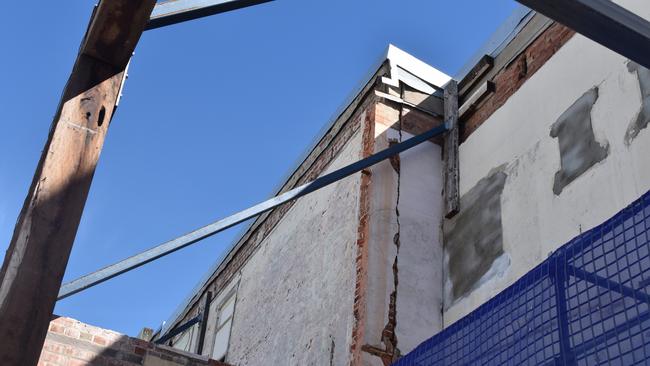 Large cracks can be seen in the wall of the former Chemist Warehouse building.